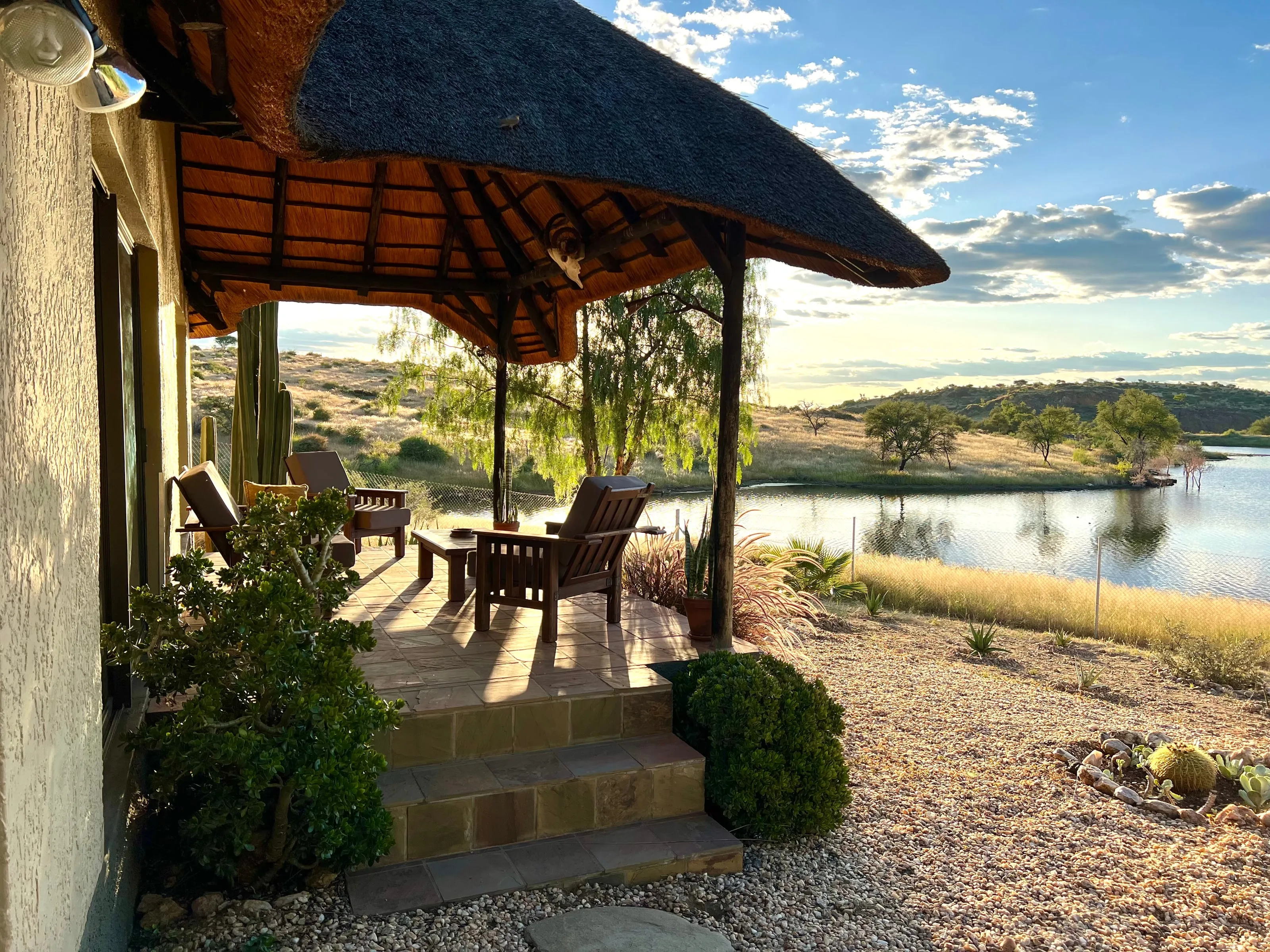 Thatched terrace of the Simmenau Chalet overlooking the lake